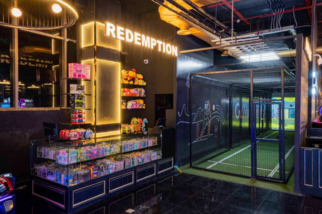 Happy family laughing while playing arcade games and bowling in Mumbai at The Game Palacio