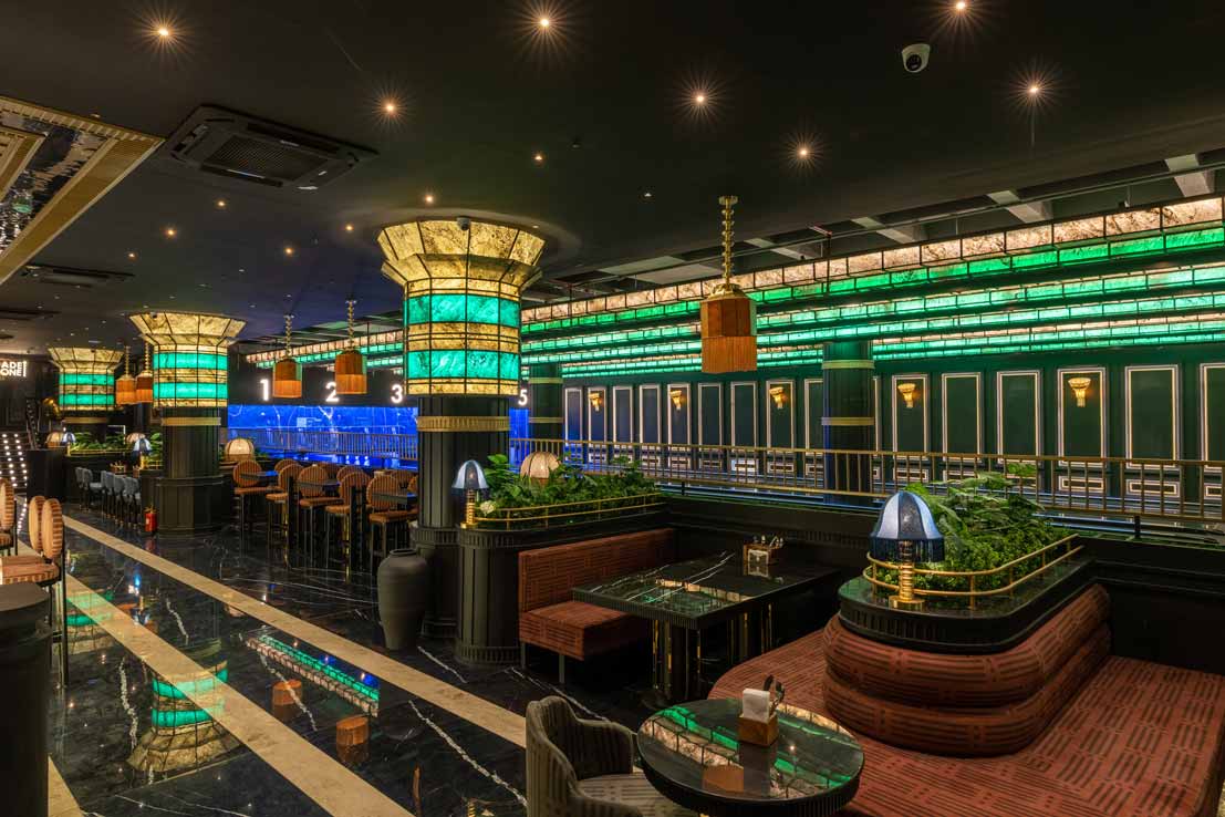 A couple enjoying a romantic dinner and fun activities like bowling at The Game Palacio in Delhi for their anniversary celebration