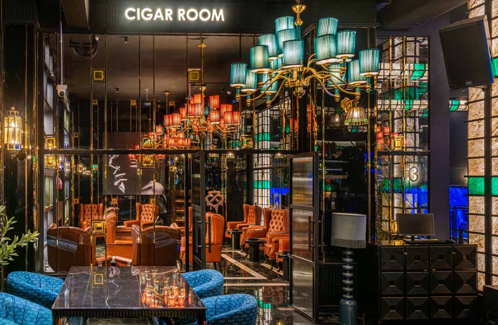 A group of friends laughing and sharing a meal at The Game Palacio restaurant and gaming venue in Lower Parel