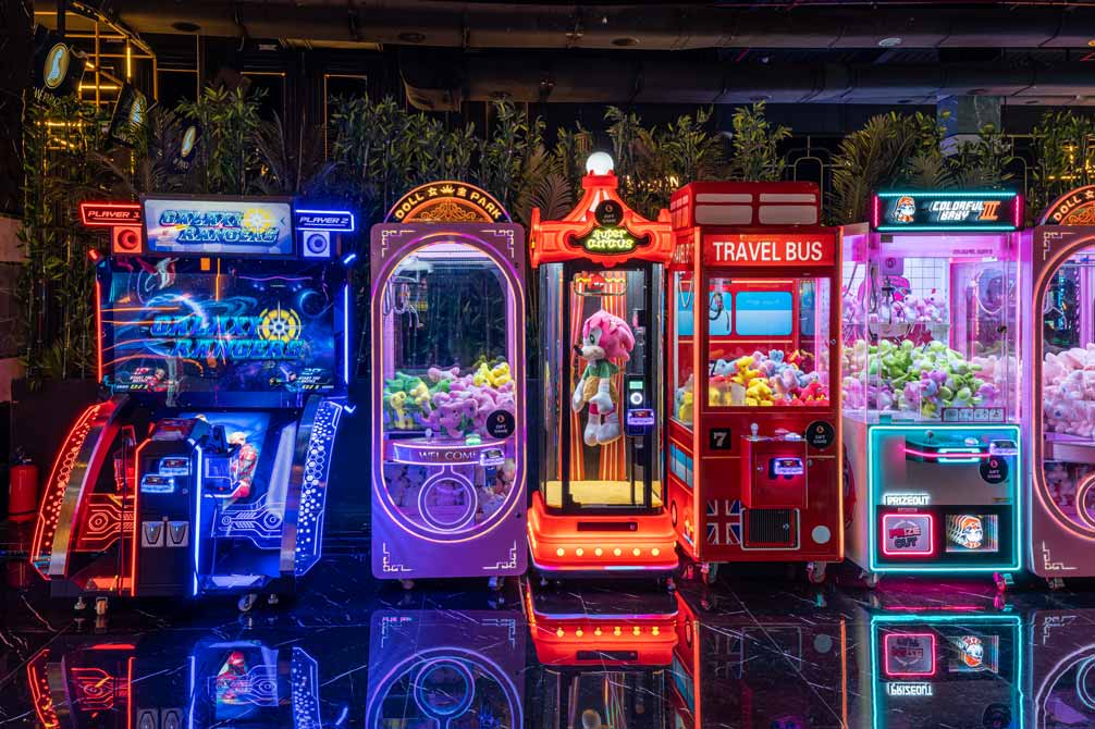 Friends enjoying drinks and playing arcade games in a stylish lounge at The Game Palacio-Hyderabad