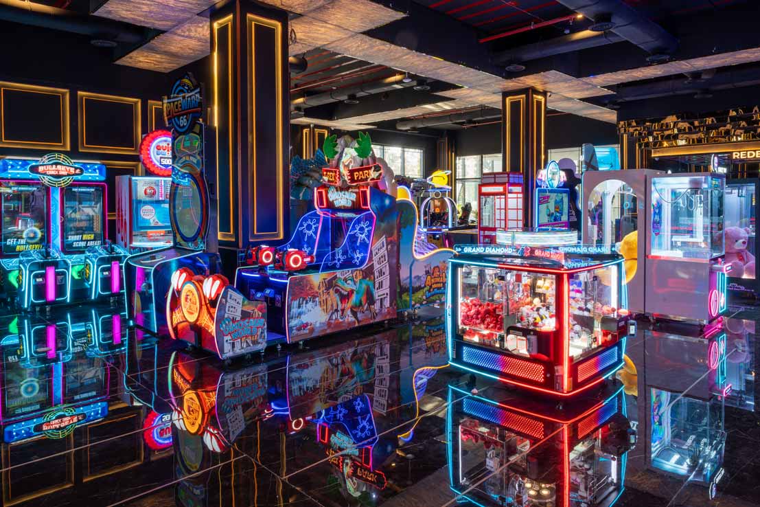 Happy children laughing and playing arcade games at The Game Palacio indoor game center.