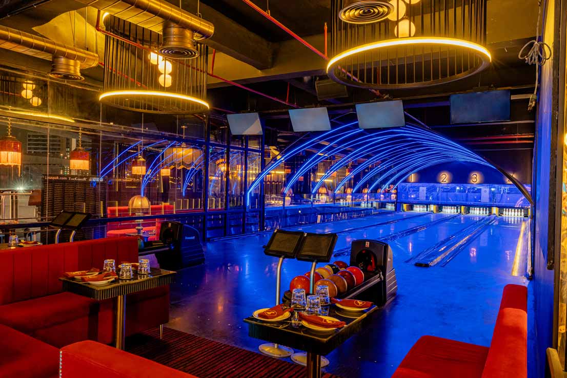 group of friends laughing and playing bowling at The Game Palacio game zone